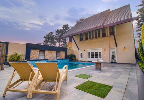 StayVista at Ekant Villa w/ Bonfire & Outdoor Pool